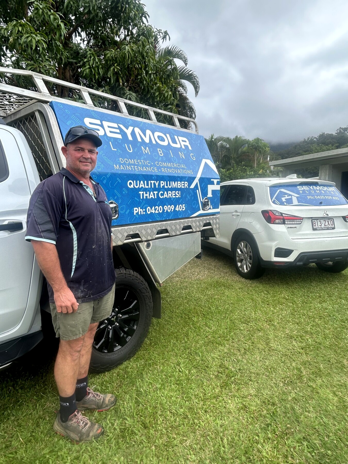 Ryan Seymour leaning against the Seymour Plumbing work vehicle